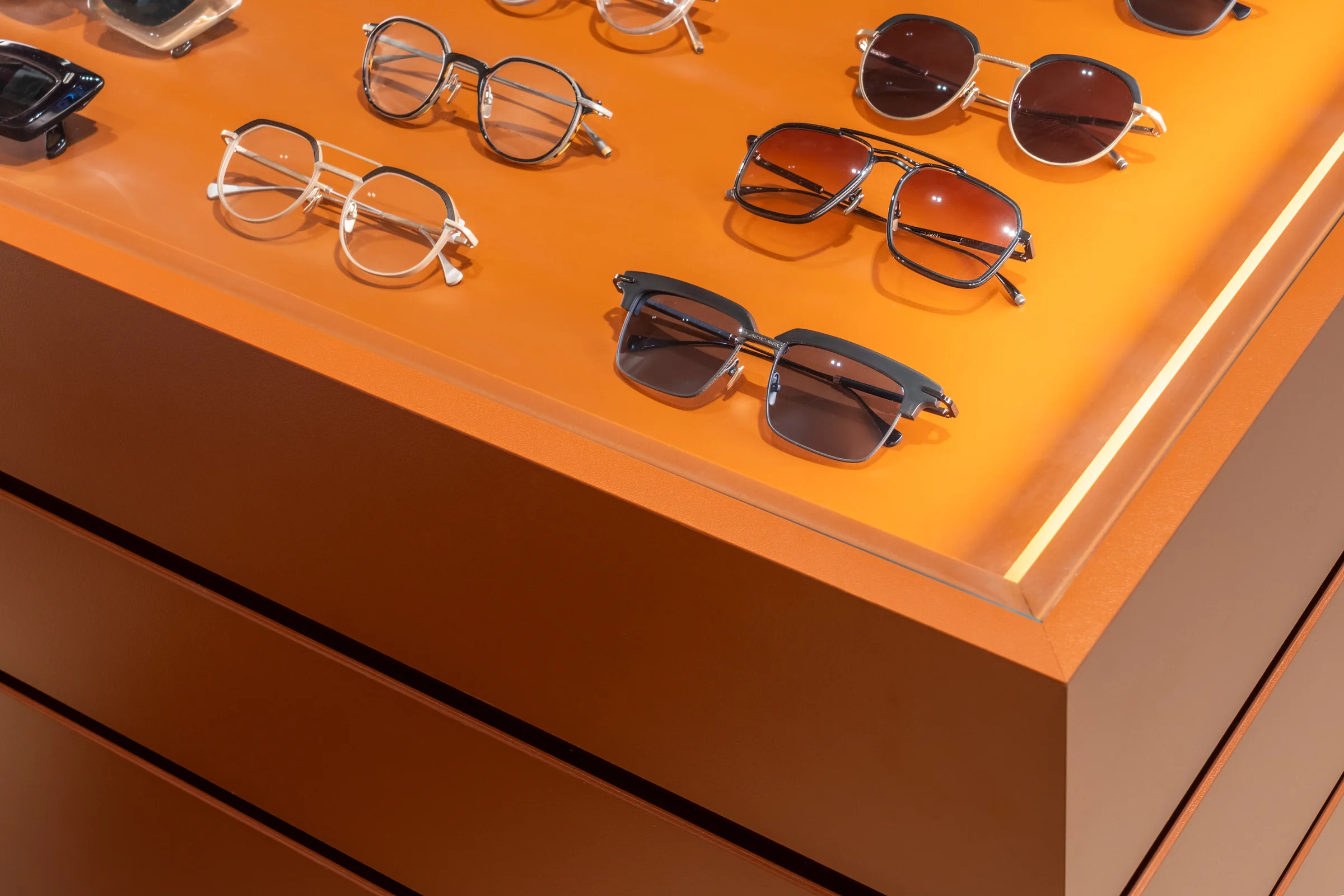 Frames on the lacquer counter under its strip light.