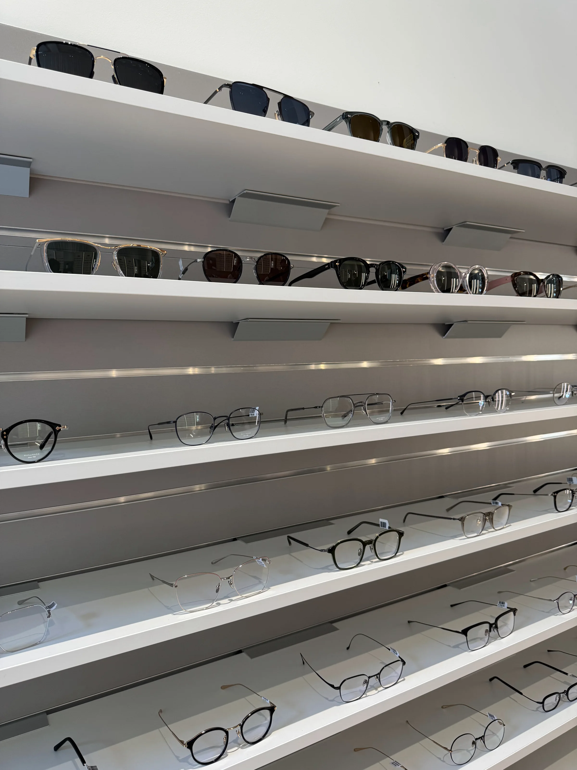 Metal frames on the white shelves, seen from the end of the run.